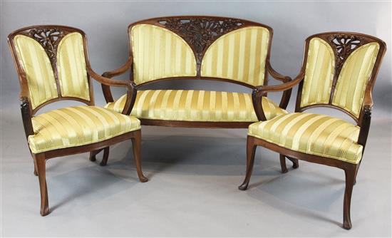 A French Art Nouveau mahogany three piece salon suite, in the manner of Majorelle, settee W.4ft 2in. H.3ft 4in.